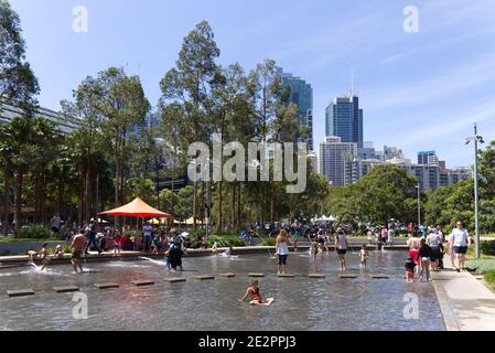 People enjoying wading water fountain in Darling Harbour Sydney New South  Wales Australia Stock Photo