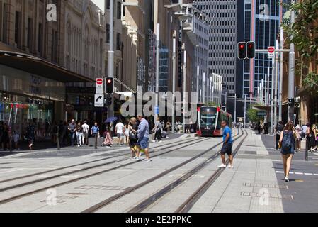 Pedestrians crossing over Light Rail system on George Street Sydney Australia Stock Photo