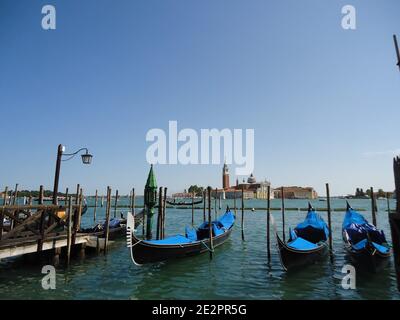 Empty venetian gondols anchored near san marco piazza Stock Photo