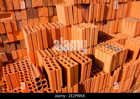 Stacks of red and brown clay bricks and blocks for general construction and reform Stock Photo