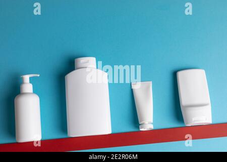 Plastic bottles or tubes for gel and cremes on a blue background Stock Photo