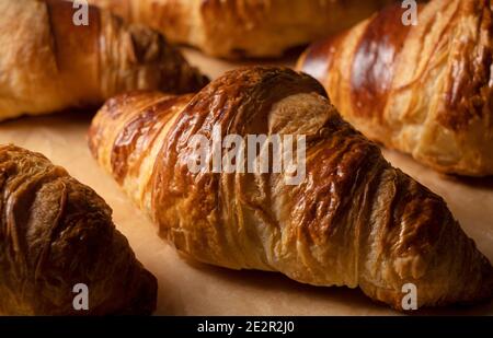 Close-up of a croissant placed on kitchen paper. Image of croissant Stock Photo