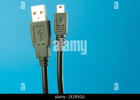 USB Type A cable on a blue background with space for text. USB cable for connecting to digital home appliances. USB (Universal Serial Bus) cable. USB Stock Photo
