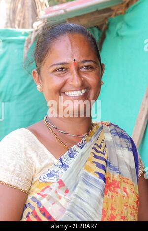 Beautiful Traditional Indian woman in sari smiles with happiness, Siolim, Goa/India-October 28,2018. Selective focus, travel photo, street photo, conc Stock Photo
