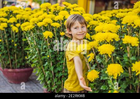 Caucasian tourist boy in Tet holidays. Vietnam Chinese Lunar New Year in springtime Stock Photo