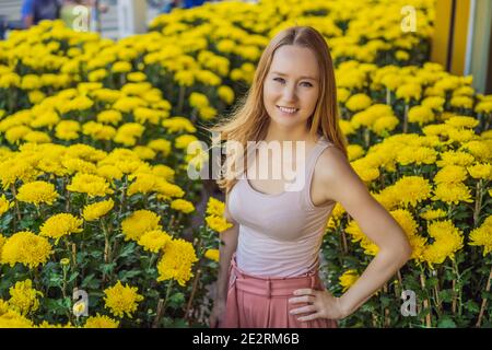 Beautiful Caucasian tourist woman in Tet holidays. Vietnam Chinese Lunar New Year in springtime Stock Photo