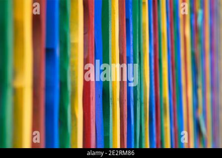 Colored wood fence. A wood fence made if colorful sticks Stock Photo