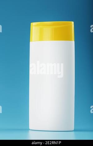 A white shampoo and shower gel bottle with a yellow lid. Free space Stock Photo