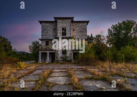 Purple sunset and old abandoned hotel on the Tara mountain, near Lake Jarevac. It was built in 1936, Tara hotel Stock Photo