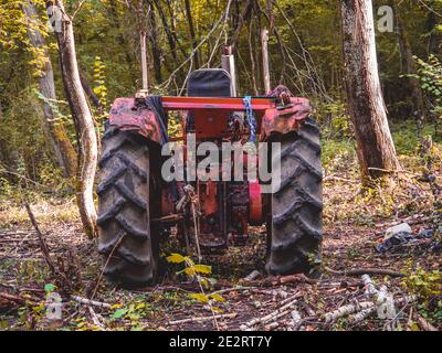Back of an abandoned Tractor in forest Stock Photo