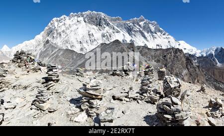 View from top of Chhukung hill over Lhotse wall with rock cairns in the foreground, Sagarmatha, Khumbu, Nepal Stock Photo