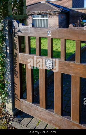 Humorous sign on a garden gate in the village of Clifton, near Ashbourne, Derbyshire - In 1832 on this spot nothing happened Stock Photo