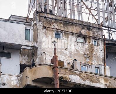 Old communist building with bullet marks or holes from the Romanian Revolution in December 1989 Stock Photo