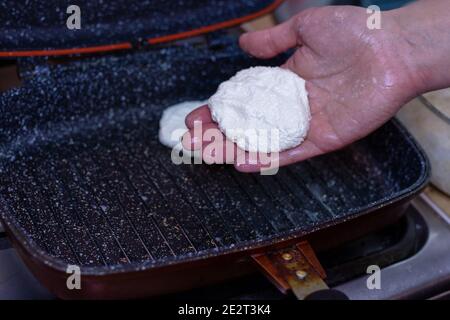 Fry cheese cakes at home in a pan Stock Photo