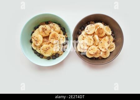 Healthy breakfast. Oatmeal with banana and flax seeds at bowl. Stock Photo