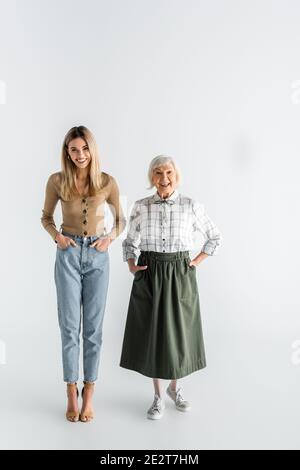 Grandmother And Granddaughter Are Standing In The Beautiful Garden