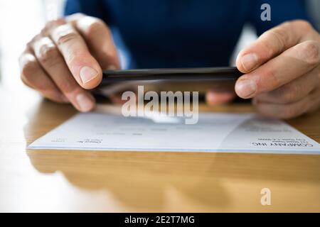 Remote Check Deposit Taking Photo With Mobile Phone Stock Photo