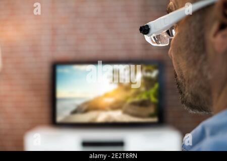 Watching TV Movie In Living Room Using Magnifying Glasses Stock Photo