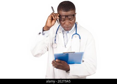 portrait of young doctor or surprised scientist raising his glasses and looking at clipboard. Stock Photo