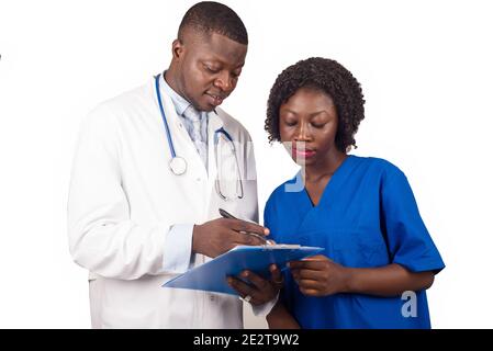 doctor standing in white coat with stethoscope on his neck explaining work to trainee smiling. Stock Photo