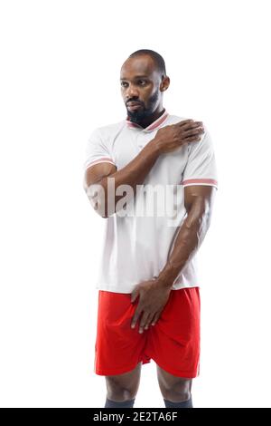 Safe and secure. Funny emotions of professional football, soccer player isolated on white studio background. Excitement in game, human emotions, facial expression and passion with sport concept. Stock Photo