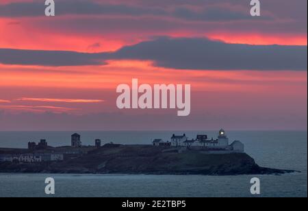 Roches Point, Cork, Ireland. 15th January, 2021.A Red dawn breaks over the south coast at Roches Point, Co. Cork, Ireland.  - Credit; David Creedon / Alamy Live News Stock Photo