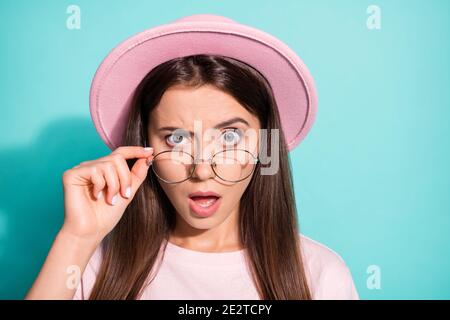 Photo portrait of suspicious pretty girl lady wear vintage headwear arm fingers touching glasses isolated turquoise color background Stock Photo