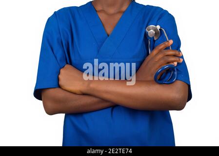 Portrait of female doctor student in blue blouse standing arms crossed over white background, holding in hand a stethoscope. Nurse concept Stock Photo