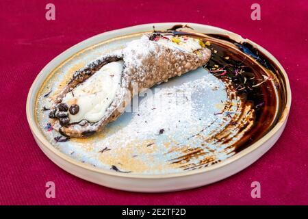 Typical Sicilian Cannoli pastry served in a restaurant of Catania, Sicily, Italy Stock Photo