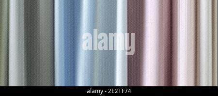 Pastel color vertical pattern background. Colorful fabrics in pastel colors, close-up. Beautiful natural fabric hanging in layers Stock Photo
