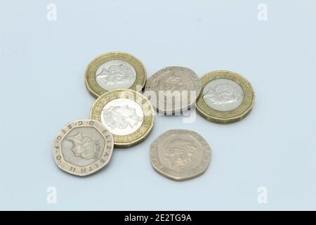 Coins of  Great British sterling currency including cash and coins on plain back ground Stock Photo