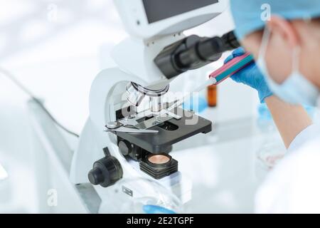 close up. researcher testing the blood under a microscope. Stock Photo