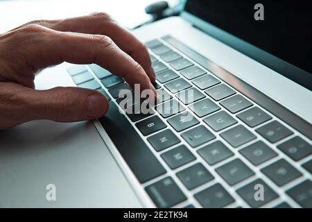 close up. man typing on a laptop keyboard. Stock Photo