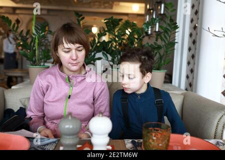 Mother and her son with menu book in cafe Stock Photo