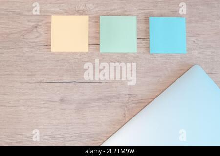 close up. sticky notes and a laptop on the table. Stock Photo