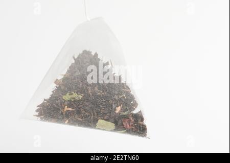 Triangle tea bag  isolated on studio background close up view Stock Photo