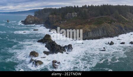The cold waters of the Pacific Ocean beat against the rocky coastline of Northern California. The Pacific Coast Highway runs along this scenic region. Stock Photo