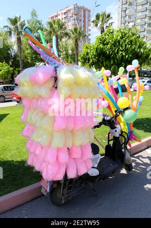 ADANA,TURKEY-APRIL 9:Colorful Cotton Candy and Balloons on a scooter on Sale at Orange Blossom Carnival.April 9,2017 in Adana,Turkey Stock Photo