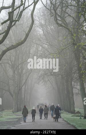 Manchester, UK, 15th Jan 2021. Members of the public are seen in the mist at Alexandra Park in Manchester during the UK’s third national lockdown in the face of the Coronavirus, Manchester, UK. Credit: Jon Super/Alamy Live News Stock Photo