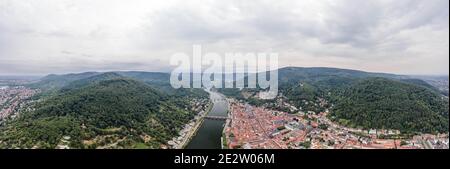 Panoramic aerial drone shot of Heidelberg old town in overcast at foot of Konigstuhl mountain Stock Photo