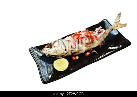 deep grilled mackerel fish topping slice shallot and chili with lemon salad on plate Stock Photo