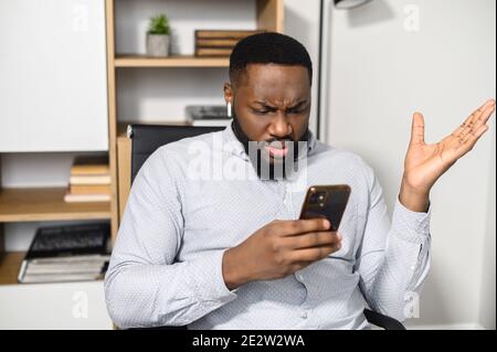 An intelligent African guy in shirt indoor Stock Photo