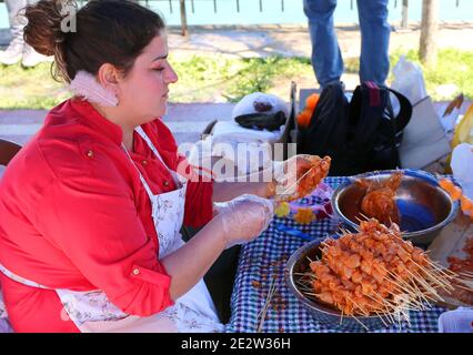 ADANA,TURKEY-APRIL 9:Unidentified woman preparing chicken shish kebabs at Orange Blossom Carnival.April 9,2017 in Adana,Turkey. Stock Photo