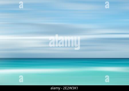 A seascape abstract with panning motion combined with a long exposure.  Image displays soft, pastel colors in a retro style. Stock Photo