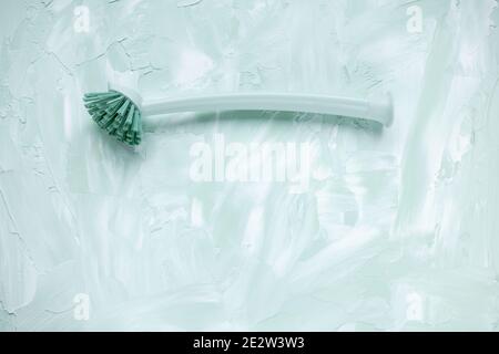 Dish washing brush on green and white background Stock Photo