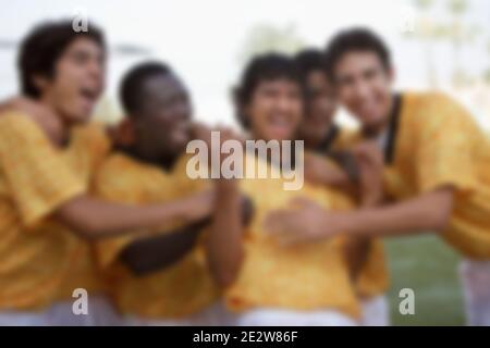 Excited multiethnic soccer players celebrating victory Stock Photo