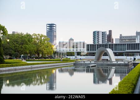 The Cenotaph at Hiroshima Peace Memorial Park, Hiroshima, Japan, in early evening. Looking across the water towards the Museum. Stock Photo