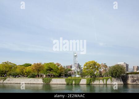 Peace Clock Tower, viewed from across the river, with sky above, Hiroshima, Japan Stock Photo