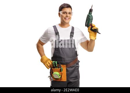 Repairman with protective goggles and a tool belt holding a drill isolated on white background Stock Photo