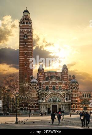 London, United Kingdom - February 02, 2019: People walking in front of Westminster Cathedral on cold day with nice afternoon clouds. It's the main cat Stock Photo